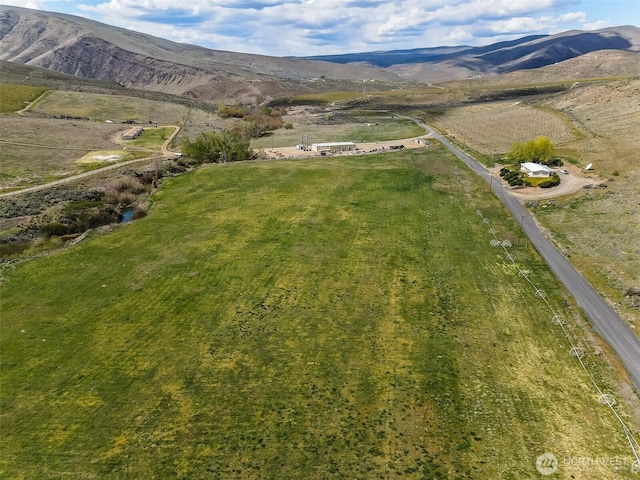 birds eye view of property with a mountain view