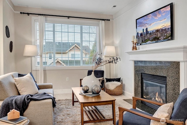 carpeted living room with visible vents, a fireplace, and baseboards