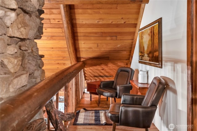 sitting room featuring wood walls and wood finished floors