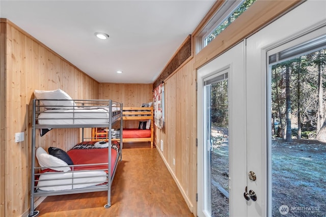 bedroom featuring wood walls and wood finished floors