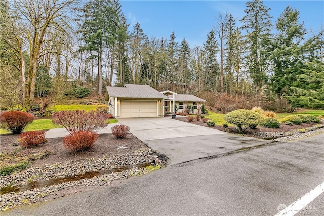 view of front of property with a garage, concrete driveway, and a porch