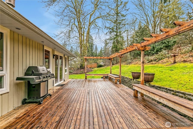 deck featuring a yard, a grill, and a pergola