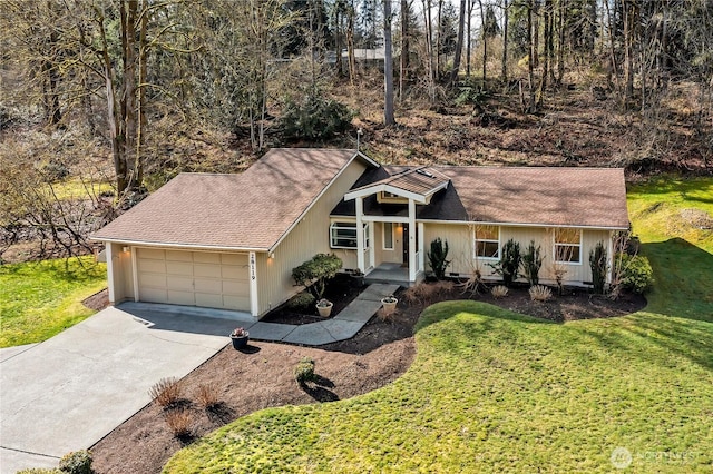 ranch-style home with a garage, concrete driveway, a shingled roof, and a front lawn