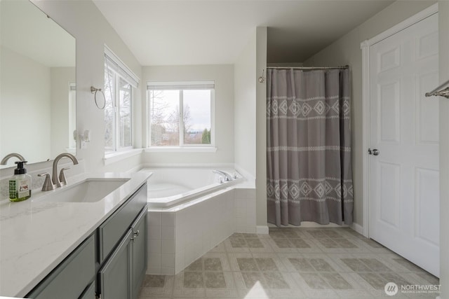 bathroom with vanity, curtained shower, and a bath