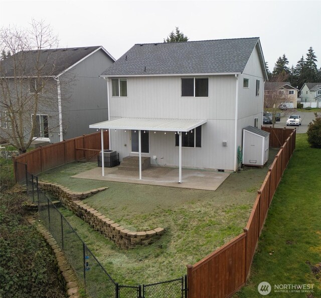 rear view of property with a patio area, a lawn, and a fenced backyard