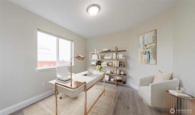 office space featuring baseboards and wood finished floors