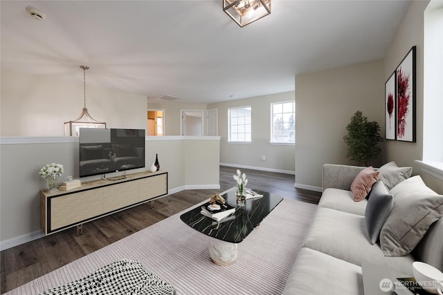 living room with baseboards and dark wood-style flooring