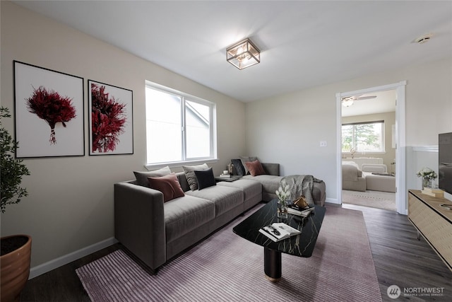 living room featuring dark wood finished floors and baseboards