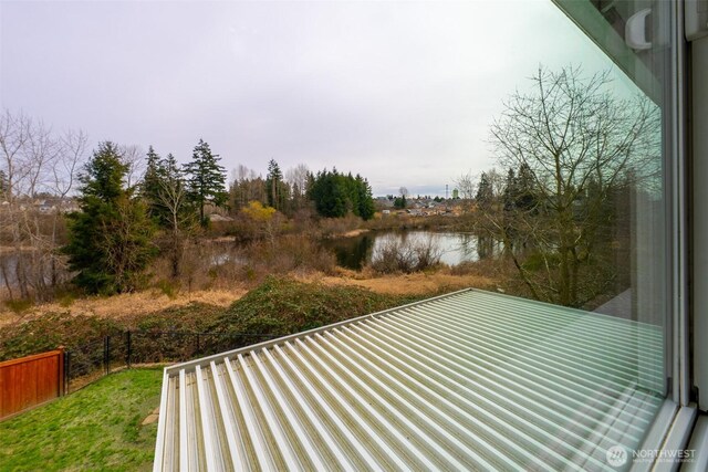 view of yard featuring a water view and fence