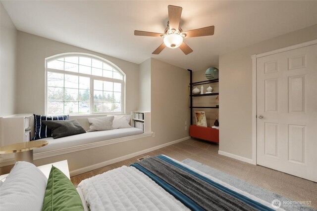 carpeted bedroom with baseboards and ceiling fan