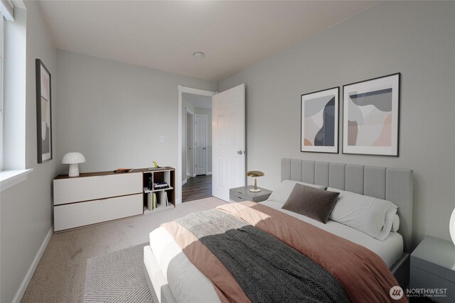 carpeted bedroom featuring baseboards