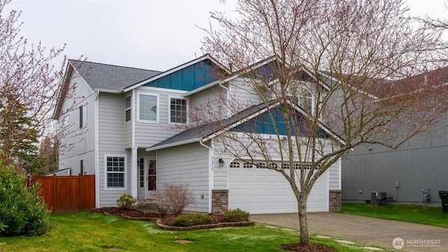 view of front of house with board and batten siding, fence, a front yard, a garage, and driveway