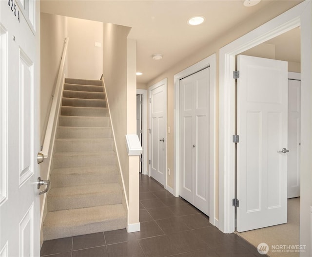 stairs featuring tile patterned flooring, baseboards, and recessed lighting