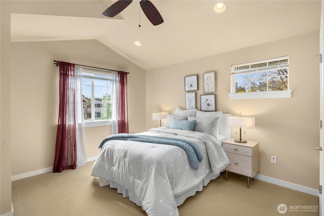 bedroom featuring light carpet, vaulted ceiling, baseboards, and ceiling fan