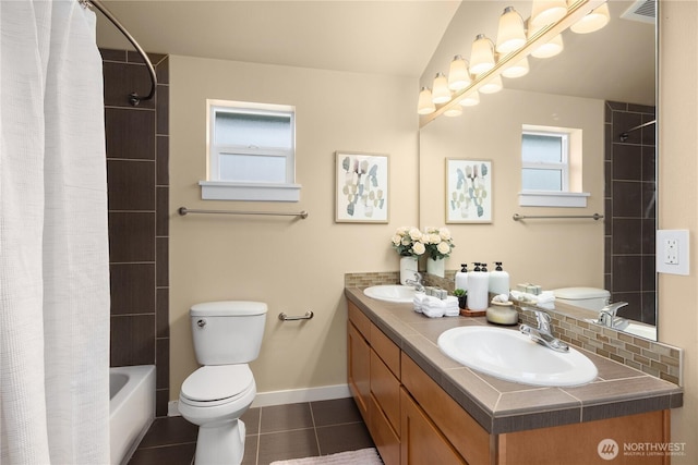 full bath featuring toilet, a sink, visible vents, and tile patterned floors