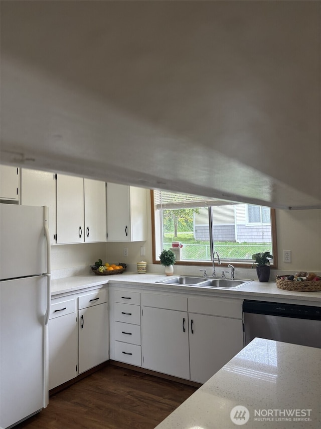 kitchen featuring a sink, dishwasher, freestanding refrigerator, and a healthy amount of sunlight