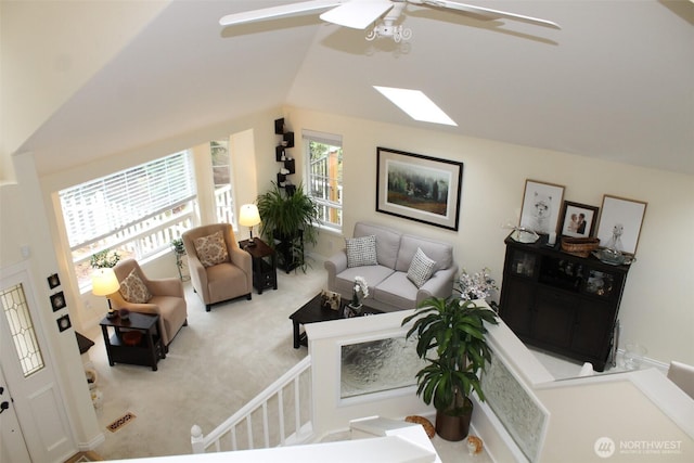 living area featuring carpet floors, a ceiling fan, and lofted ceiling