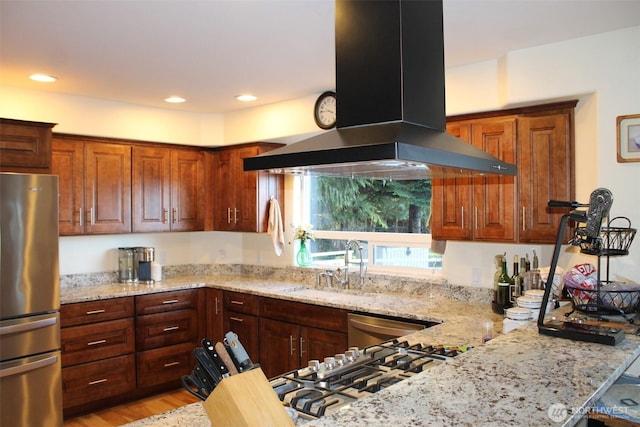 kitchen with light stone countertops, island exhaust hood, appliances with stainless steel finishes, and recessed lighting