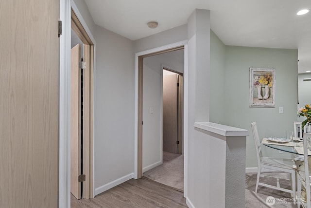 hall featuring baseboards and wood finished floors