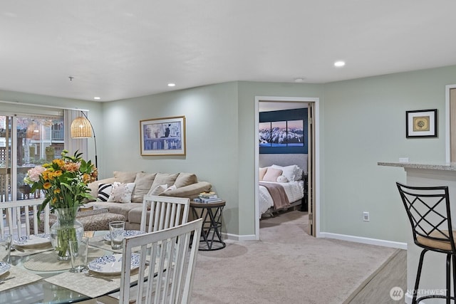 living room with recessed lighting, baseboards, and carpet