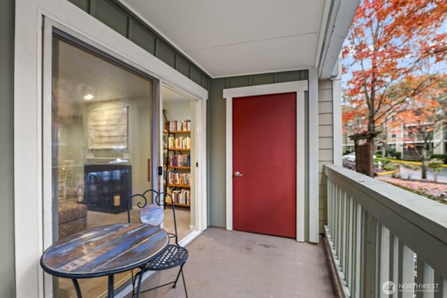 doorway to property featuring a balcony and board and batten siding