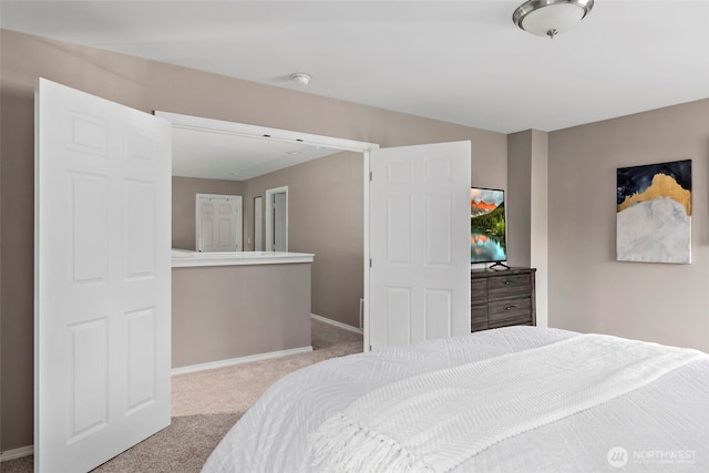 bedroom featuring carpet and baseboards