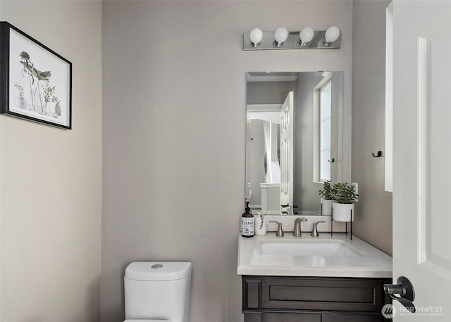 bathroom with toilet and vanity