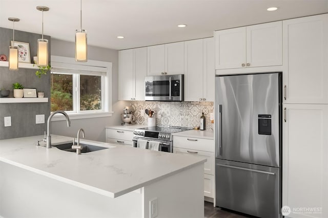 kitchen with open shelves, appliances with stainless steel finishes, white cabinetry, a sink, and a peninsula