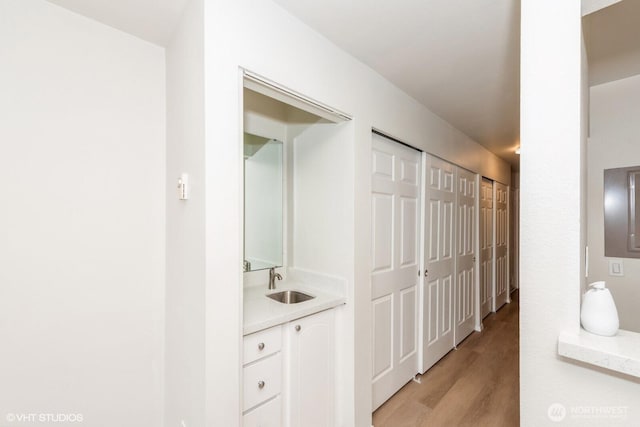 1221 Harbor Ave SW Unit 105, Seattle, WA 98116 - hall featuring a sink and light wood-type flooring