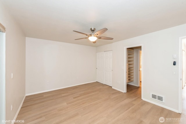 1221 Harbor Ave SW Unit 105, Seattle, WA 98116 - unfurnished bedroom featuring light wood-style floors, baseboards, a closet, and a ceiling fan