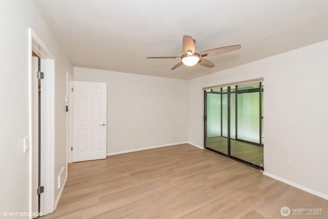 1221 Harbor Ave SW Unit 105, Seattle, WA 98116 - spare room with ceiling fan, light wood-style floors, and baseboards