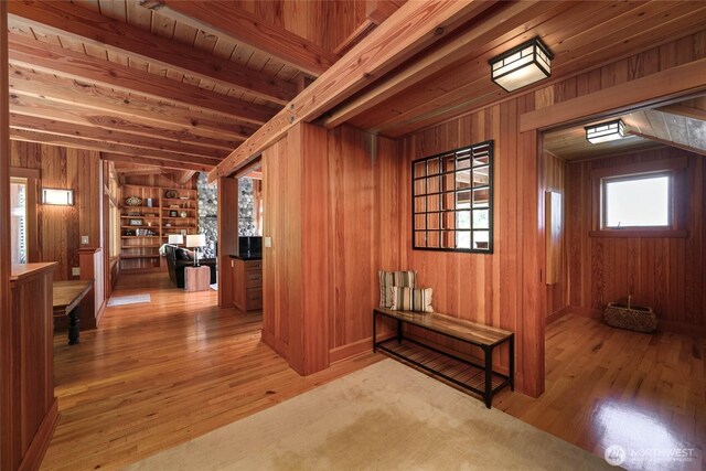 707 NW Thatcher Pass Rd, Decatur Island, WA 98221 - hallway featuring light wood-type flooring, wood walls, and beam ceiling