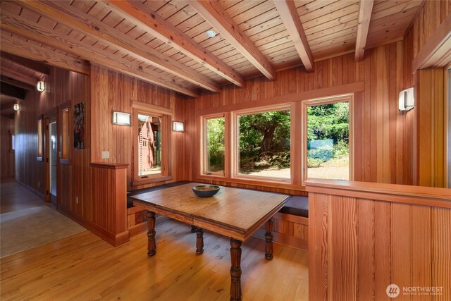 707 NW Thatcher Pass Rd, Decatur Island, WA 98221 - unfurnished dining area featuring wooden walls, light wood-style flooring, wood ceiling, and beamed ceiling