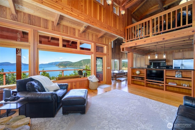 707 NW Thatcher Pass Rd, Decatur Island, WA 98221 - living room featuring light wood-style floors, wooden walls, wood ceiling, a mountain view, and beam ceiling