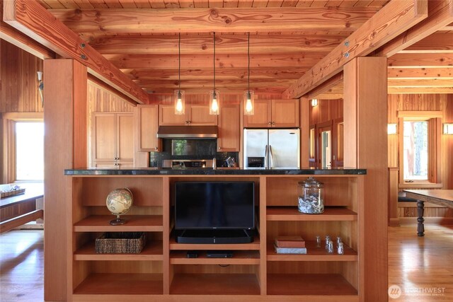 707 NW Thatcher Pass Rd, Decatur Island, WA 98221 - kitchen with open shelves, dark countertops, stainless steel refrigerator with ice dispenser, under cabinet range hood, and wooden ceiling