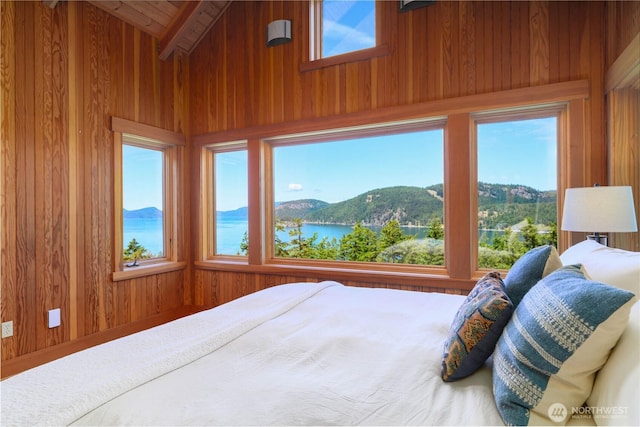 707 NW Thatcher Pass Rd, Decatur Island, WA 98221 - bedroom featuring wooden walls, vaulted ceiling with beams, and a water and mountain view