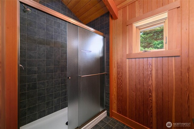 707 NW Thatcher Pass Rd, Decatur Island, WA 98221 - full bath featuring a shower stall, wooden walls, tile patterned flooring, and lofted ceiling