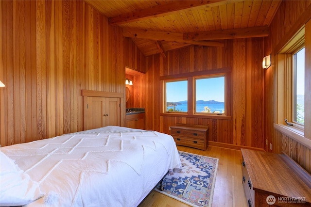 707 NW Thatcher Pass Rd, Decatur Island, WA 98221 - bedroom with wooden walls, wood ceiling, hardwood / wood-style floors, and lofted ceiling with beams