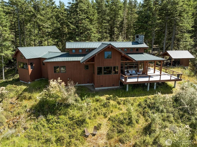 707 NW Thatcher Pass Rd, Decatur Island, WA 98221 - back of house with a forest view, crawl space, metal roof, and a standing seam roof