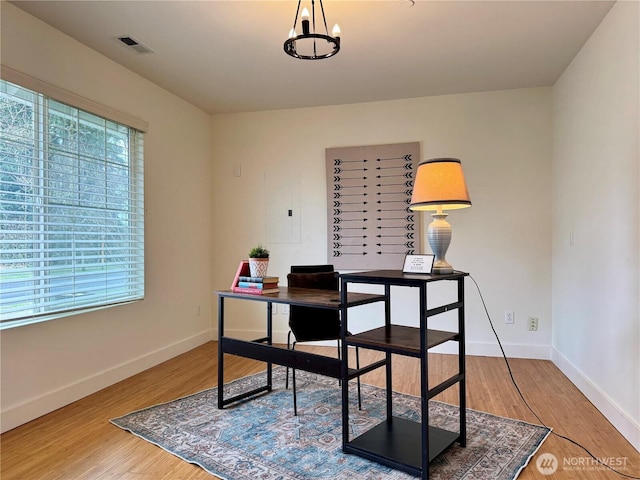 office with visible vents, baseboards, a notable chandelier, and wood finished floors