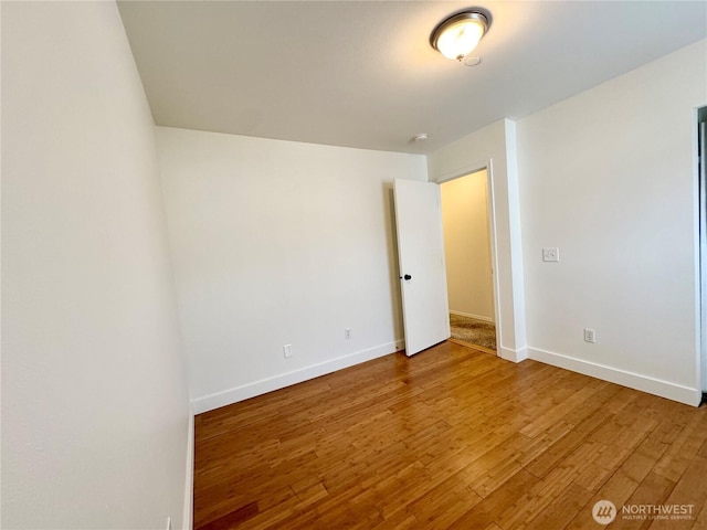 unfurnished bedroom with baseboards and wood finished floors