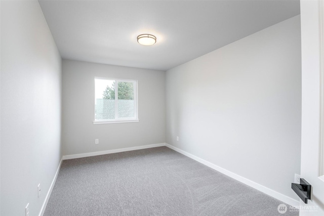 empty room with carpet floors and baseboards