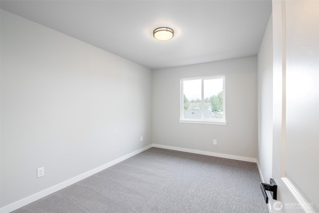 carpeted spare room with baseboards