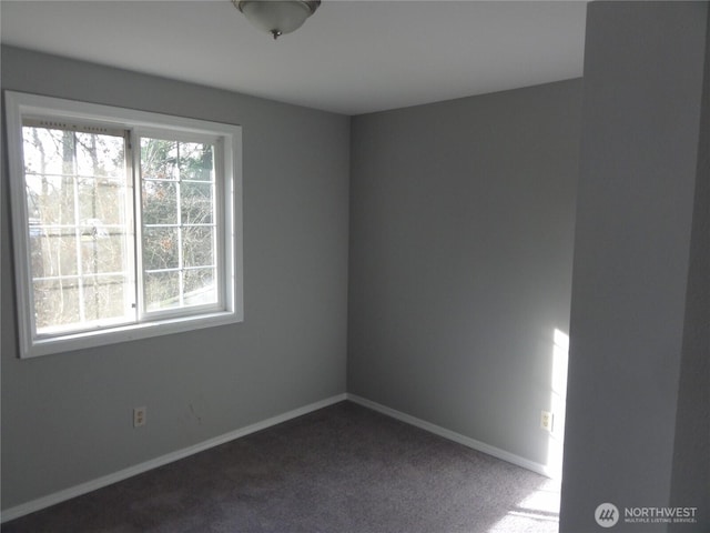 carpeted empty room with baseboards