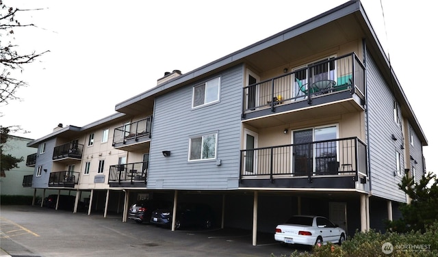 view of building exterior with covered parking