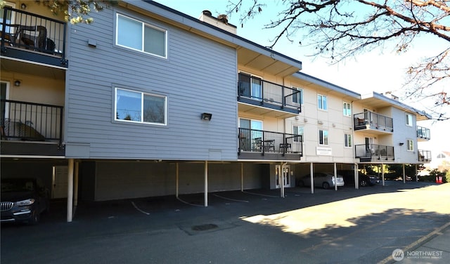 view of building exterior with covered parking