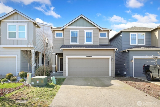 view of front facade with an attached garage, board and batten siding, and concrete driveway