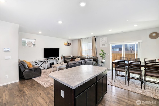 kitchen featuring light countertops, recessed lighting, dark wood-style floors, and a kitchen island