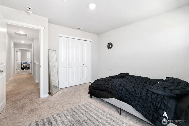 bedroom with baseboards, carpet, a closet, and visible vents