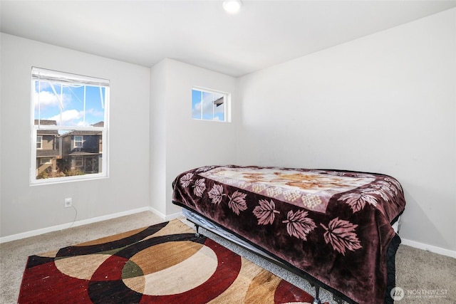 carpeted bedroom featuring baseboards